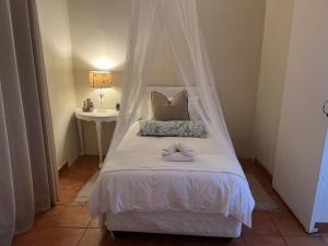 a bedroom with a bed with a canopy at Haze Inn Cottage in Rosetta