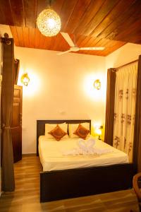 a bedroom with a bed with two hearts on it at Sea Turtles Bungalow in Bentota +59 photos