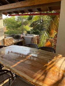 a wooden table and chairs on a patio at Kalyva Cottage in Myrina
