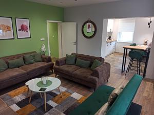 a living room with two couches and a table at Dream House in Vršac