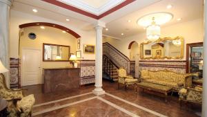 a living room with a staircase and a mirror at Hotel Maestranza in Seville