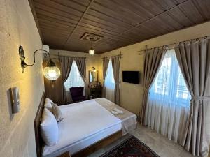 Postel nebo postele na pokoji v ubytování Virtus Cappadocia Hotel Göreme