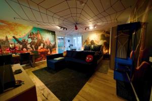 a living room with a spider man mural on the wall at EDLER WOHNRAUM Disney Marvel Studio mit Boxspringbett, Netflix, Einbaukaffeevollautomat, Terrasse & Lift in Chemnitz