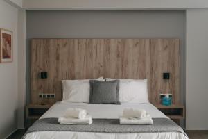 a bedroom with a large bed with two towels on it at Vialmar Premium Apartments in Rio