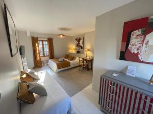 a hotel room with a bed and a living room at La Haute Flourie - bed and breakfast -chambres d'hôtes in Saint Malo