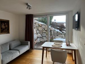 a living room with a couch and a table at Apartment Am Birkenweg in Oberndorf in Tirol