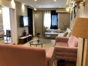 a living room with a couch and a table at Luxury apartment in Mohandiseen in Cairo