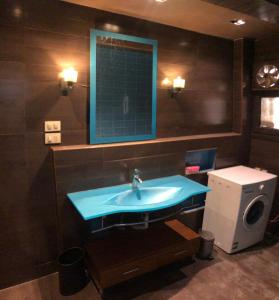 a bathroom with a blue sink and a mirror at Luxury apartment in Mohandiseen in Cairo