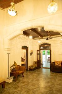 a large living room with chairs and a couch at Ranagiri Relaxing Bungalow in Bentota