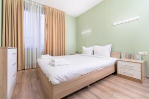 a bedroom with a large bed and a large window at City Central 1-Bed Apartments in Plovdiv