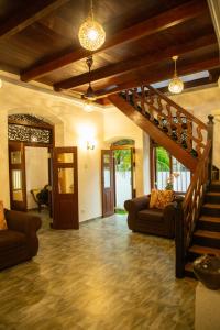 a living room with a staircase in a house at Ranagiri Relaxing Bungalow in Bentota