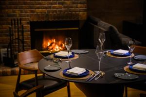 a table with wine glasses and a fireplace at Otaru Geihinkan in Otaru