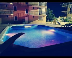 a large swimming pool in front of a building at Apartment Blue Komfort in Sunny Beach