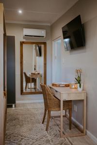 a dining room with a table and a mirror at Lavender BnB in East London