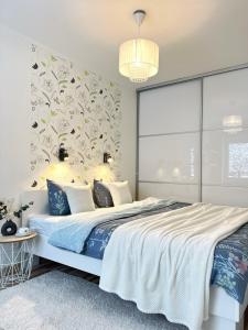 a bedroom with a large bed with a floral wall at Comfort Apartment In Narva City Center in Narva