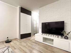a living room with a large flat screen tv at Comfort Apartment In Narva City Center in Narva