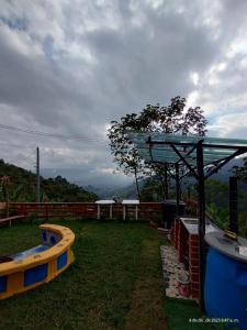 a backyard with a gazebo and two play equipment at finca casita el mirador in Medellín