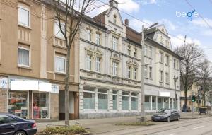 a building on a street with cars parked in front of it at BEGE APARTMENTS: WORKSPOT in Gelsenkirchen