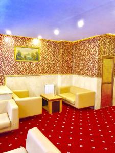 a living room with yellow furniture and a red carpet at MARDİA CİTY OTEL in Istanbul