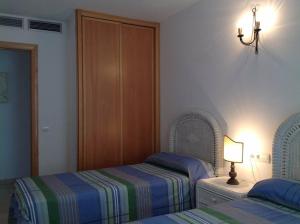 Ένα ή περισσότερα κρεβάτια σε δωμάτιο στο App Mar de Pujols 3 - FormenteraLodge