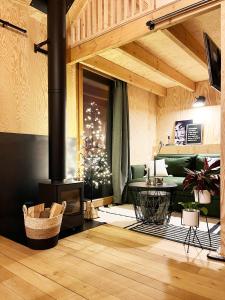 a living room with a fireplace and a christmas tree at Bayda's Tiny House in Sprimont