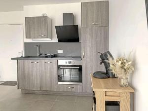 una cucina con piano cottura, lavandino e tavolo di Appartement Berck-Plage, 2 pièces, 4 personnes - FR-1-646-36 a Berck-sur-Mer