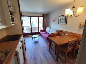 a living room with a couch and a table at Appartement cosy sud, 4 pers, près du funiculaire - FR-1-292-197 in Isola