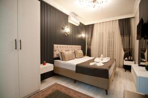 a bedroom with a bed and a chandelier at Hotel Broken Column in Istanbul