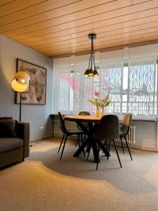 a living room with a dining room table and chairs at Kleinwalsertal Apartment in Mittelberg