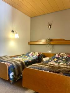 a room with two beds in a room at Kleinwalsertal Apartment in Mittelberg