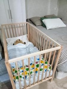 a crib with a dog laying in it at Loft independiente FORGET ME NOT in Getxo