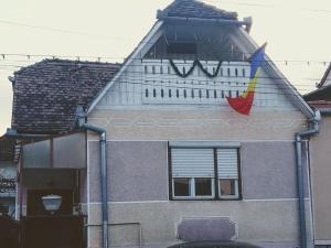 a building with a flag on the side of it at Casa Roxy in Cristian