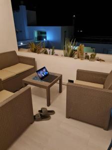 a room with chairs and a table with a laptop on it at Apartment Casa M in Morro Jable in Morro del Jable