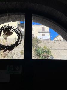 two windows in a room with a view of a building at DOMUS VELA in Fornelli