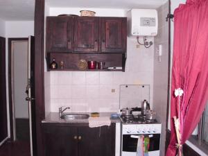 a small kitchen with a sink and a stove at La Pastora in Punta del Este