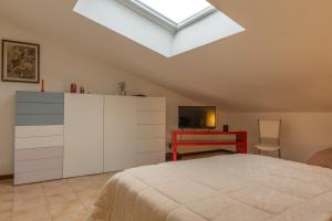 a bedroom with a bed and a skylight at Archi di Vesna II in Ancona
