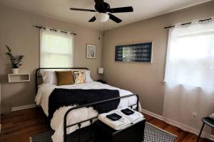 1 dormitorio con 1 cama y ventilador de techo en Cozy house near Lake Erie, 10 minutes to Downtown., en Cleveland