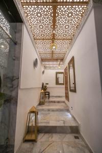 a hallway of a building with a ceiling with lights at Palais Chahd Luxury in Fez