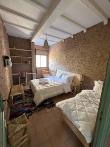 Ένα ή περισσότερα κρεβάτια σε δωμάτιο στο Tazart Lodge