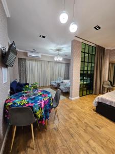a living room with a table and a couch at Nova city center apartments in Tbilisi City