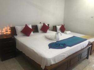 Postel nebo postele na pokoji v ubytování Tamaro Beach Resort