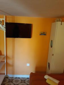 a living room with a flat screen tv on the wall at Apartment Nada in Veli Lošinj