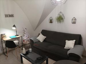 a living room with a black couch and a christmas tree at Appart. sur Caen avec Garage et Wifi. in Caen