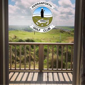 Blick auf ein Schild des Golfclubs aus dem Fenster in der Unterkunft Perranporth Golf Club Self-Catering Holiday Accommodation in Perranporth