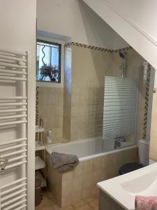 a bathroom with a tub and a sink at Rooftop appartement centre Arenes in Nîmes