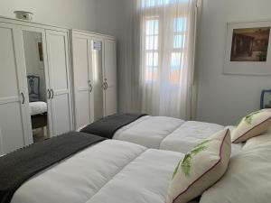 a bedroom with three white beds in it at Meriga in Agulo