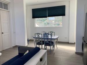 a dining room with a blue table and chairs at Meriga in Agulo