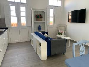 a living room with a blue couch and a tv at Meriga in Agulo