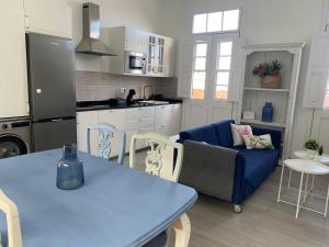a kitchen and living room with a blue table and chairs at Meriga in Agulo