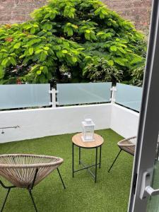 a balcony with two chairs and a table on the grass at Meriga in Agulo